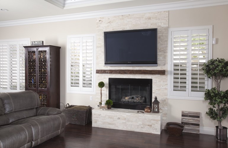 White plantation shutters in a Salt Lake City living room with plank hardwood floors.